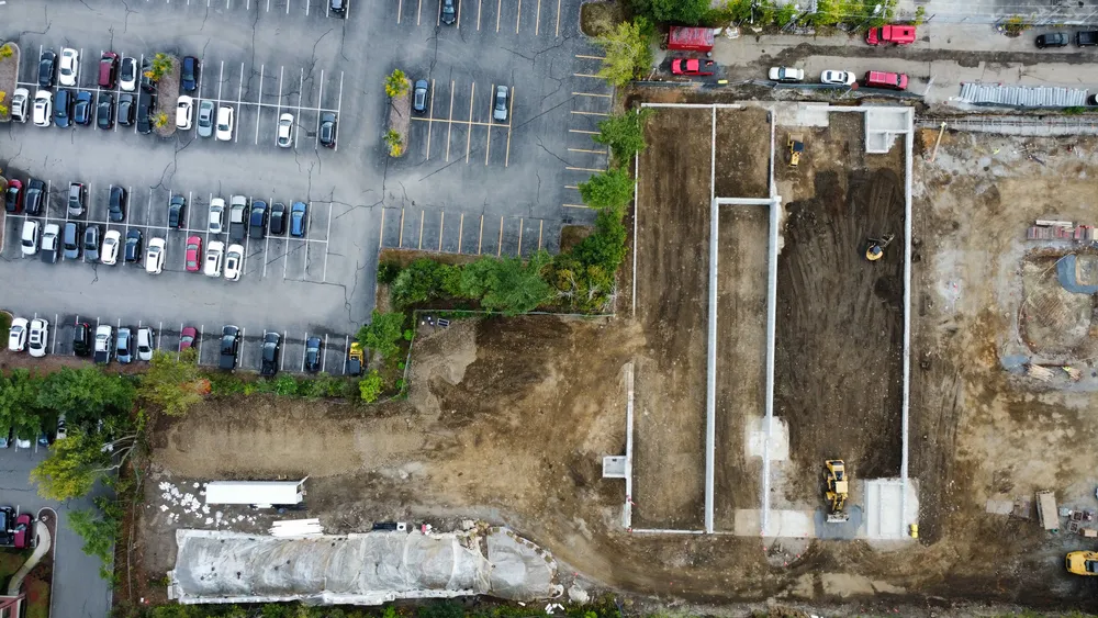 Excavators and bulldozers on site prepping for concrete